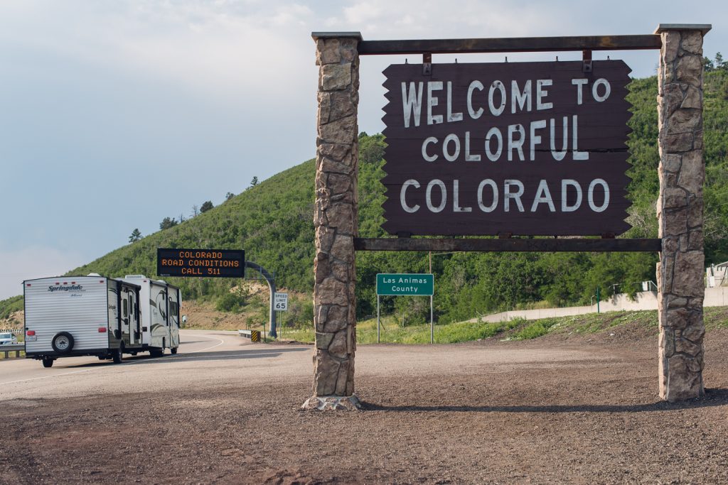 state sign rv road trip driving colorado new mexico scenery landscape